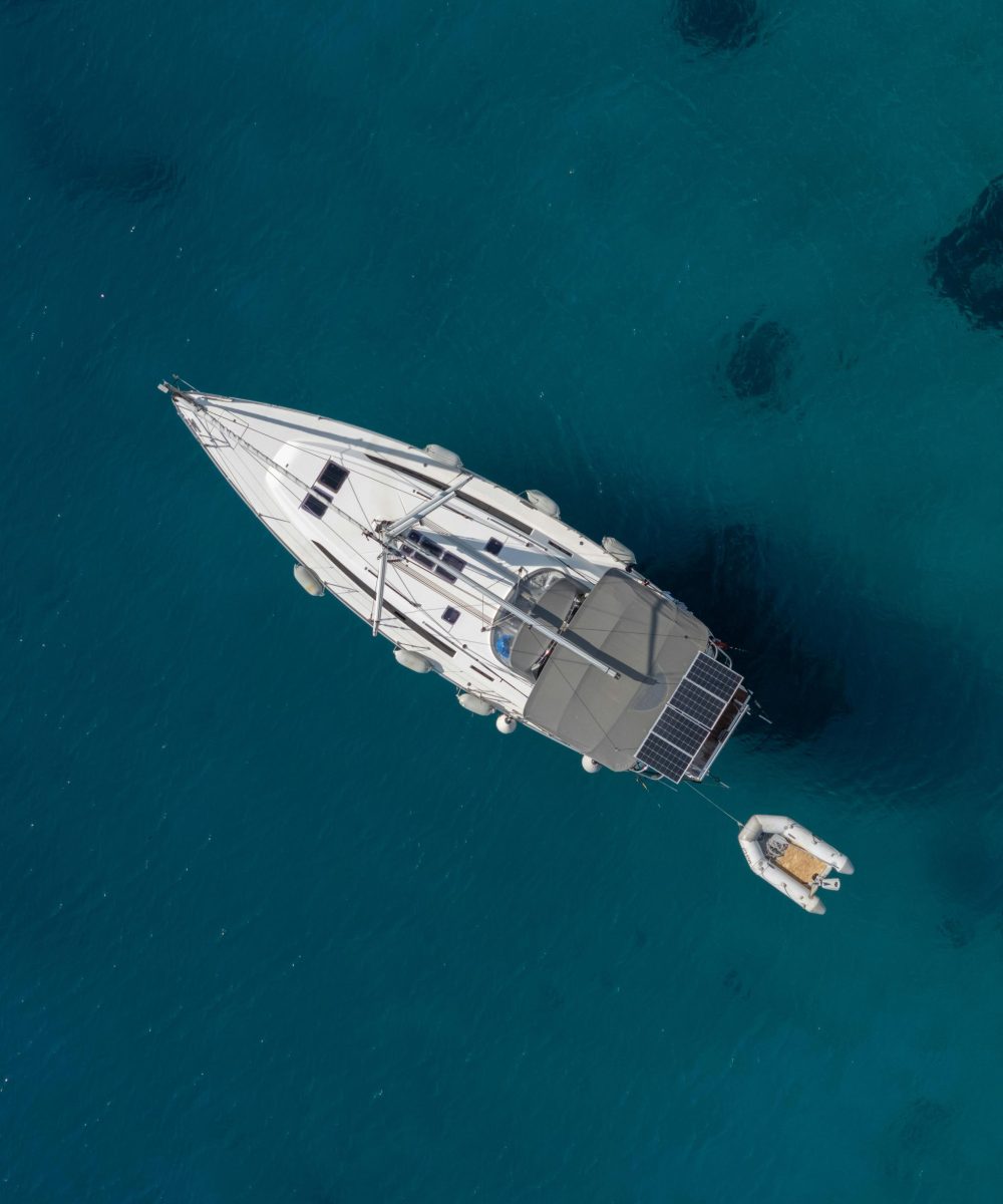 Aerial view of a luxury yacht anchored in the crystal-clear waters of Bodrum, Türkiye.